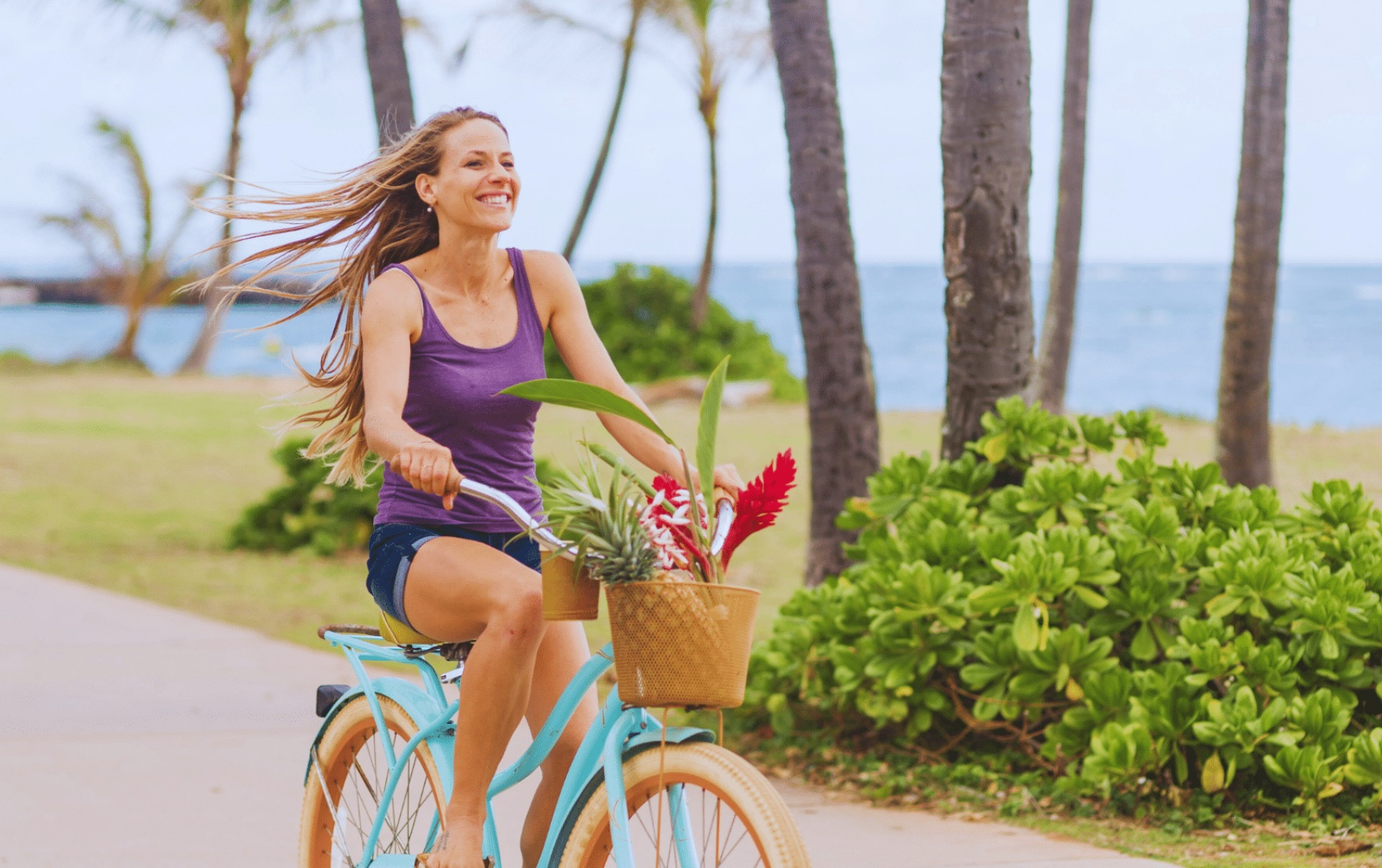 Woman rinding a bike on the Kapaa bike path